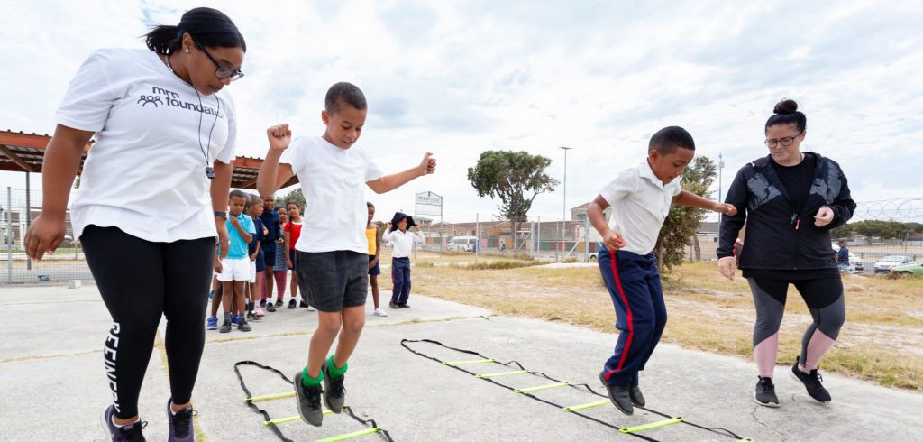 Young learners enjoying physical education at a primary school in Mitchell's Plain.